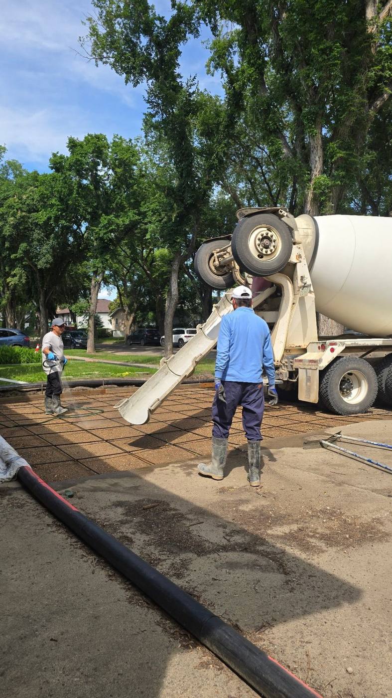 Mixer truck set up to pour a residential garage slab in Saskatoon